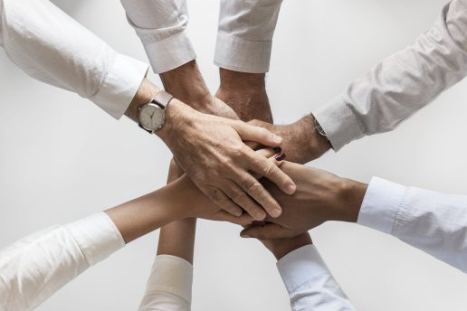 business-hands-joined-together-teamwork-min business-hands-joined-together-teamwork-min